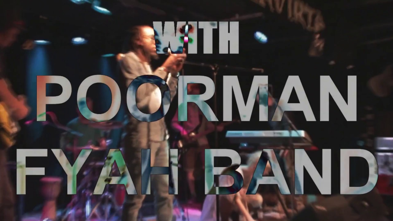 Video still: the words With Poorman Fyah Band over a band on stage under coloured lights